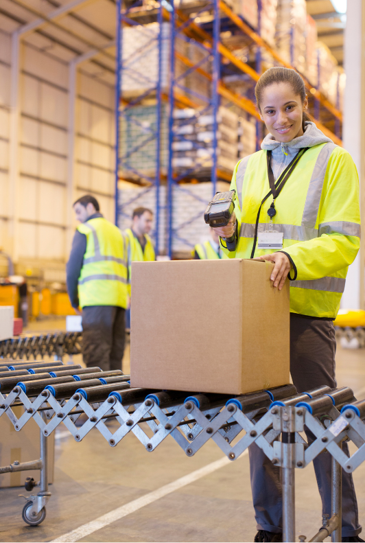 female warehouse worker scanning a box