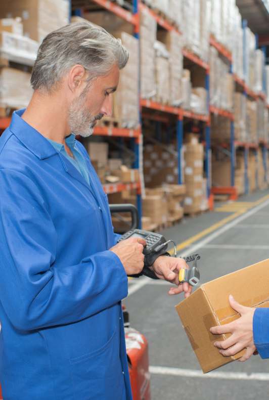 man using wrist device to scan a box