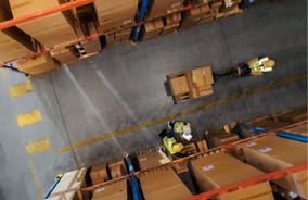 people working in a warehouse as seen from above